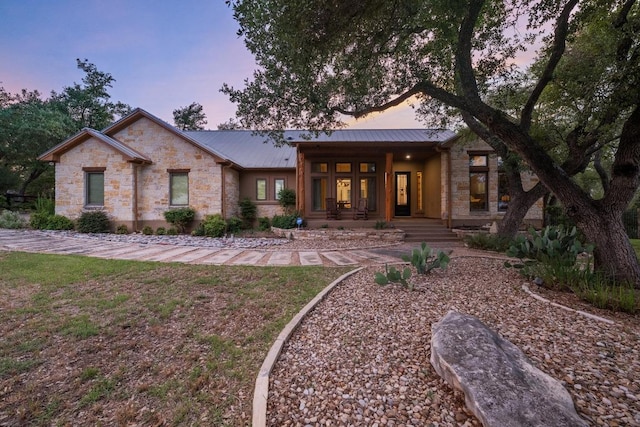 116 Horseshoe Dr, Dripping Springs, TX 78620 - view of front of home featuring covered porch, stone siding, and metal roof