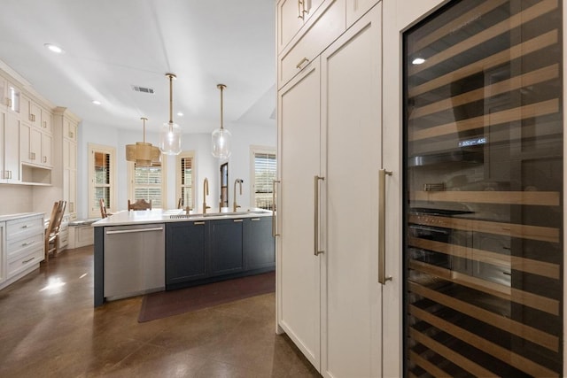 116 Horseshoe Dr, Dripping Springs, TX 78620 - kitchen featuring stainless steel dishwasher, beverage cooler, a sink, recessed lighting, and a center island with sink