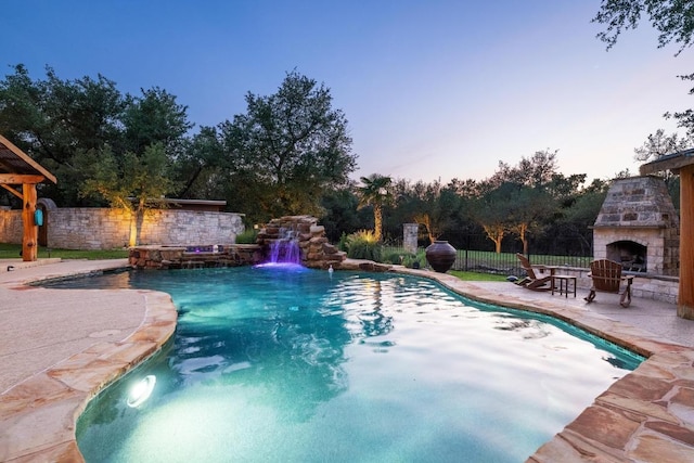 116 Horseshoe Dr, Dripping Springs, TX 78620 - view of swimming pool with an outdoor stone fireplace and a patio area