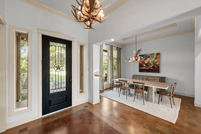 116 Horseshoe Dr, Dripping Springs, TX 78620 - entryway featuring a chandelier, ornamental molding, healthy amount of natural light, dark tile patterned floors, and baseboards