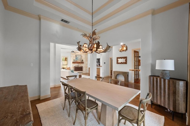 116 Horseshoe Dr, Dripping Springs, TX 78620 - dining space featuring crown molding, a towering ceiling, a tray ceiling, a chandelier, and baseboards