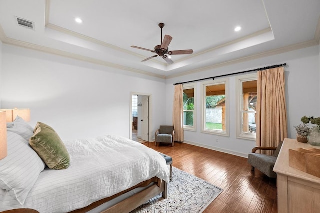 116 Horseshoe Dr, Dripping Springs, TX 78620 - bedroom featuring a raised ceiling, crown molding, hardwood / wood-style floors, baseboards, and recessed lighting