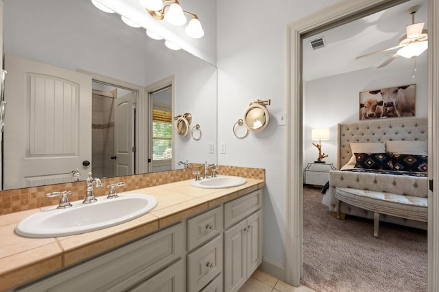 116 Horseshoe Dr, Dripping Springs, TX 78620 - full bathroom featuring connected bathroom, double vanity, a ceiling fan, a shower, and tile patterned floors
