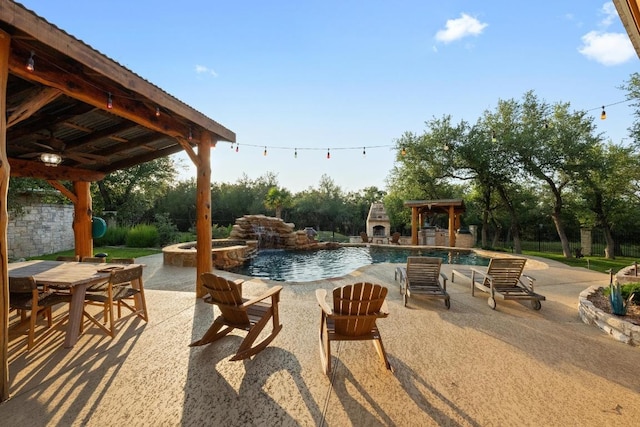 116 Horseshoe Dr, Dripping Springs, TX 78620 - view of patio with a ceiling fan, a gazebo, a pool with connected hot tub, an outdoor stone fireplace, and outdoor dining space