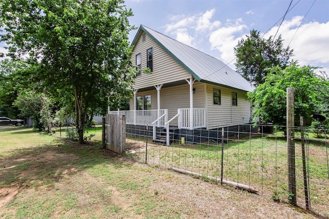 125 San Jacinto St, Bastrop, TX 78602 - view of property exterior with covered porch and metal roof