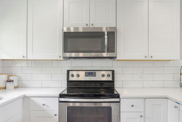 125 San Jacinto St, Bastrop, TX 78602 - kitchen featuring stainless steel appliances, white cabinetry, decorative backsplash, and light countertops