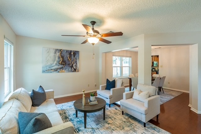 1202 Tremont Dr, Cedar Park, TX 78613 - living room featuring a textured ceiling, wood finished floors, a ceiling fan, and baseboards