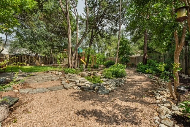 1202 Tremont Dr, Cedar Park, TX 78613 - fenced backyard with a playground