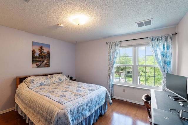 1202 Tremont Dr, Cedar Park, TX 78613 - bedroom featuring baseboards, wood finished floors, and a textured ceiling