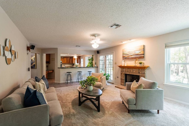 1202 Tremont Dr, Cedar Park, TX 78613 - living area featuring a textured ceiling, a brick fireplace, light colored carpet, and baseboards