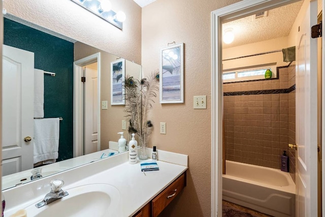 1202 Tremont Dr, Cedar Park, TX 78613 - bathroom featuring a textured wall, vanity, and tub / shower combination