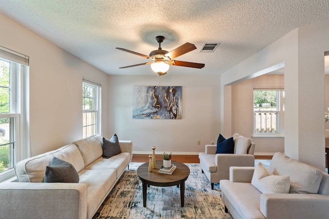 1202 Tremont Dr, Cedar Park, TX 78613 - living area with ceiling fan, a textured ceiling, wood finished floors, and baseboards