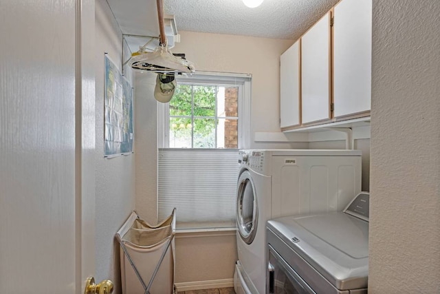 1202 Tremont Dr, Cedar Park, TX 78613 - laundry room featuring cabinet space, separate washer and dryer, a textured ceiling, and a textured wall