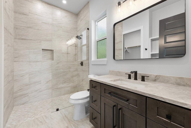14804 Arrowhead Dr, Leander, TX 78641 - bathroom with tiled shower, vanity, marble finish floors, and recessed lighting
