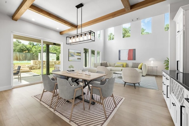 14804 Arrowhead Dr, Leander, TX 78641 - dining space featuring beam ceiling, light wood-style flooring, recessed lighting, and a towering ceiling