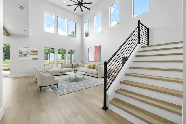14804 Arrowhead Dr, Leander, TX 78641 - living room featuring a towering ceiling, wood finished floors, stairway, and recessed lighting