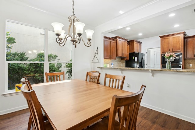 308 Hills Of Texas Trl, Georgetown, TX 78633 - dining area featuring a chandelier, dark wood finished floors, baseboards, recessed lighting, and ornamental molding
