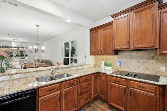 308 Hills Of Texas Trl, Georgetown, TX 78633 - kitchen with black appliances, a sink, light stone countertops, decorative backsplash, and decorative light fixtures