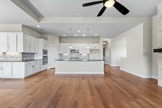 18716 Waltz Ct, Austin, TX 78738 - kitchen featuring appliances with stainless steel finishes, dark countertops, tasteful backsplash, under cabinet range hood, and ceiling fan
