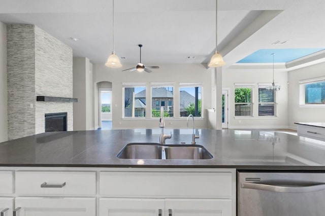 18716 Waltz Ct, Austin, TX 78738 - kitchen with stainless steel dishwasher, open floor plan, a sink, and dark countertops