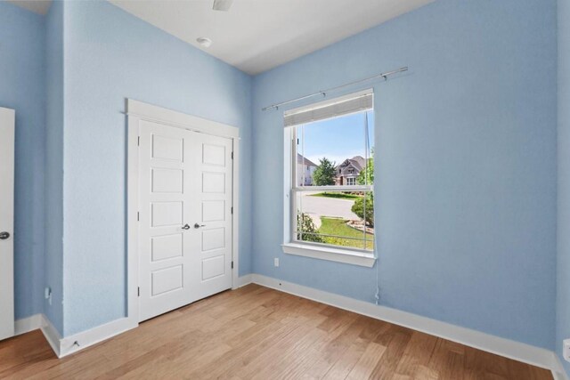 18716 Waltz Ct, Austin, TX 78738 - unfurnished bedroom featuring wood finished floors and baseboards