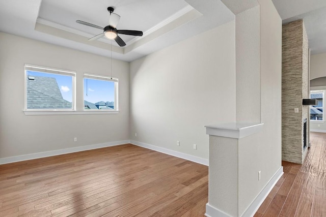 18716 Waltz Ct, Austin, TX 78738 - unfurnished room featuring a raised ceiling, wood finished floors, ceiling fan, and baseboards
