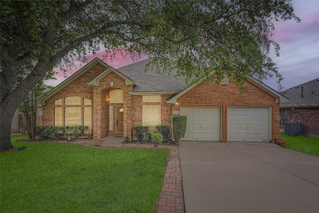 905 Point Run Dr, Pflugerville, TX 78660 - traditional home with concrete driveway, an attached garage, a shingled roof, a lawn, and cooling unit