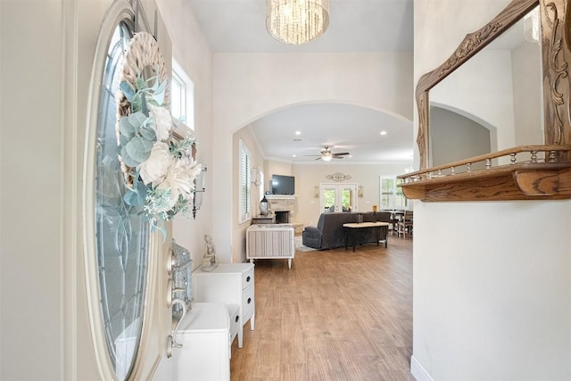 108 Kaliu Ct, Bastrop, TX 78602 - foyer entrance featuring arched walkways, ceiling fan, light wood finished floors, a chandelier, and recessed lighting