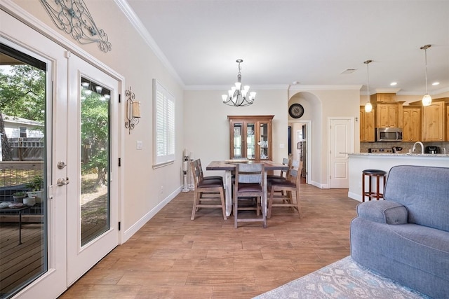 108 Kaliu Ct, Bastrop, TX 78602 - dining room featuring a chandelier, crown molding, and light wood finished floors