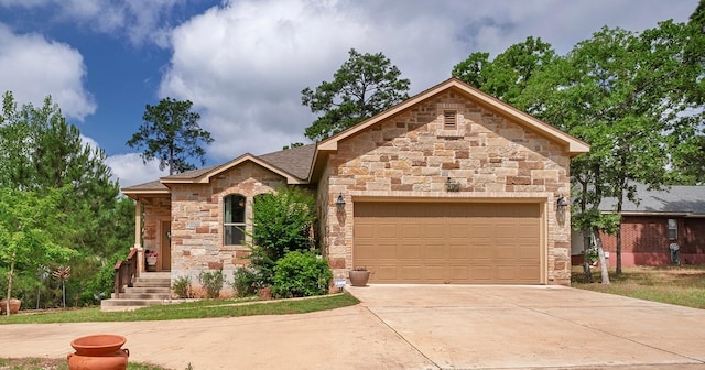 108 Kaliu Ct, Bastrop, TX 78602 - view of front of house featuring an attached garage, driveway, and stone siding