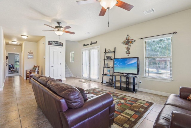 600 Augusta Cir N, Point Venture, TX 78645 - tiled living room featuring a ceiling fan, baseboards, and stairway