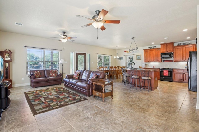 600 Augusta Cir N, Point Venture, TX 78645 - living room featuring ceiling fan, recessed lighting, a chandelier, light tile patterned floors, and baseboards