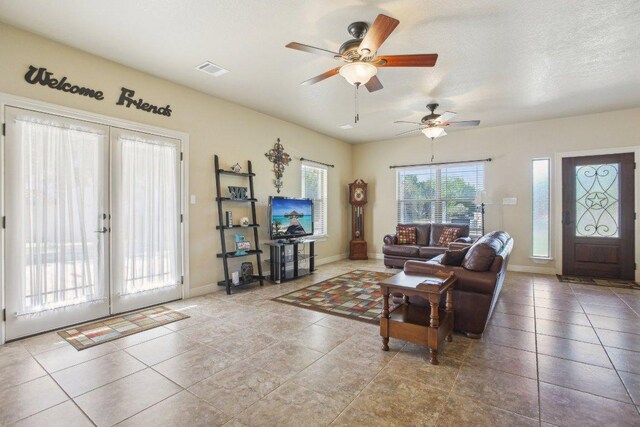 600 Augusta Cir N, Point Venture, TX 78645 - tiled living room with a ceiling fan, baseboards, and french doors