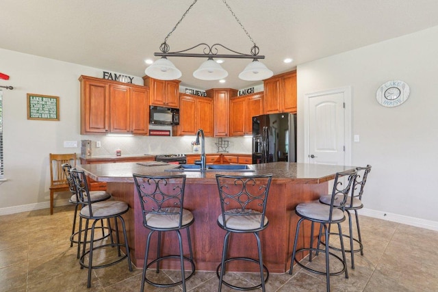 600 Augusta Cir N, Point Venture, TX 78645 - kitchen with black appliances, baseboards, a sink, backsplash, and recessed lighting