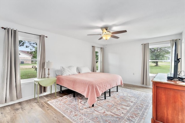 283 Rockdale W Rd, Rockdale, TX 76567 - bedroom featuring light wood-type flooring, ceiling fan, and baseboards