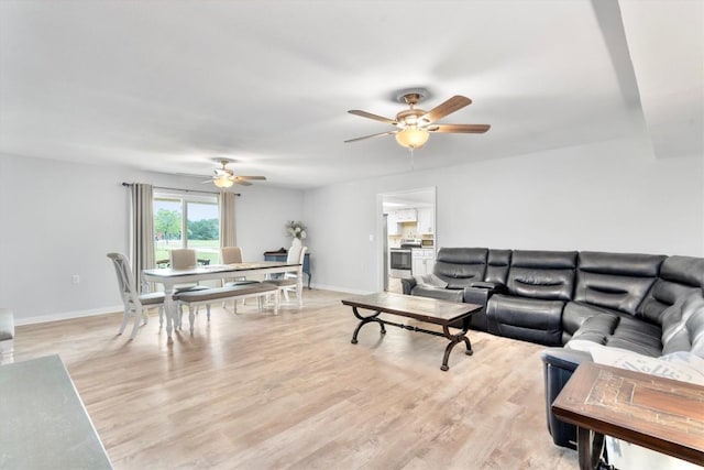 283 Rockdale W Rd, Rockdale, TX 76567 - living room with a ceiling fan, baseboards, and light wood-style floors