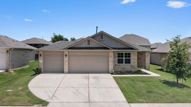632 Otto Ave, Georgetown, TX 78626 - view of front of house featuring concrete driveway, an attached garage, a front lawn, and stone siding
