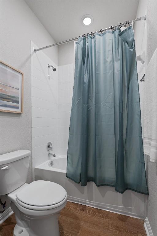 632 Otto Ave, Georgetown, TX 78626 - bathroom featuring shower / tub combo and wood finished floors