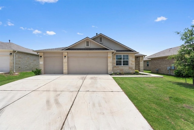632 Otto Ave, Georgetown, TX 78626 - single story home with concrete driveway, a garage, a front lawn, and stone siding