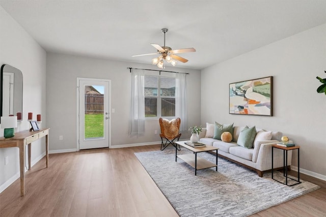 632 Otto Ave, Georgetown, TX 78626 - living room with light wood-style floors, a ceiling fan, and arched walkways
