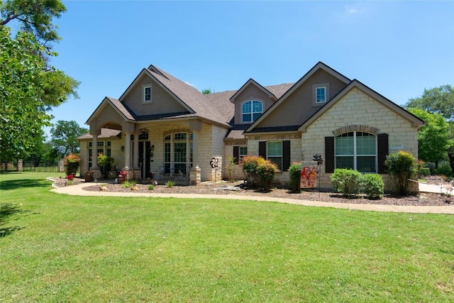 1265 Mourning Dove Ct, Salado, TX 76571 - craftsman-style house with a front lawn, stone siding, covered porch, and stucco siding