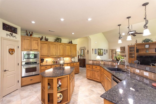 1265 Mourning Dove Ct, Salado, TX 76571 - kitchen featuring appliances with stainless steel finishes, a large island with sink, a sink, backsplash, and dark stone counters