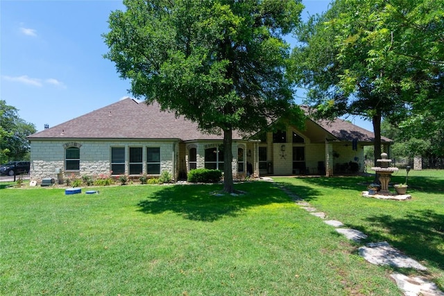 1265 Mourning Dove Ct, Salado, TX 76571 - back of house featuring stone siding, a lawn, and roof with shingles