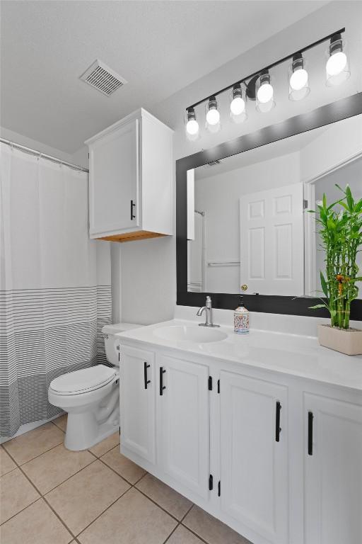 14708 Single Trce, Austin, TX 78728 - bathroom with vanity, toilet, and tile patterned flooring