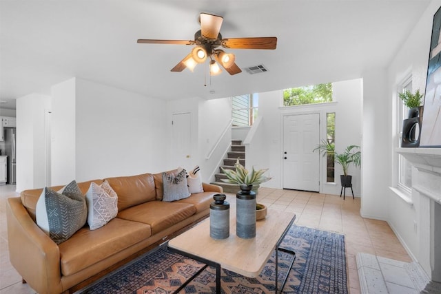14708 Single Trce, Austin, TX 78728 - living room with stairs, a ceiling fan, baseboards, and light tile patterned floors