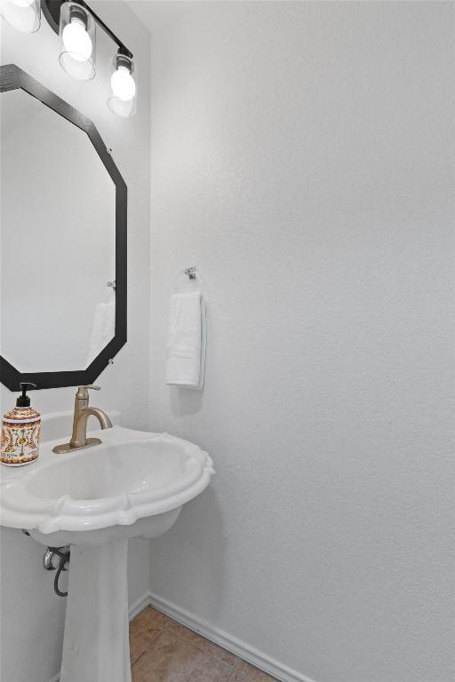 14708 Single Trce, Austin, TX 78728 - bathroom with baseboards, tile patterned flooring, and a sink