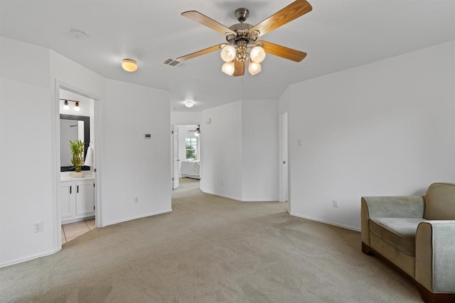 14708 Single Trce, Austin, TX 78728 - living area with light carpet, a ceiling fan, and baseboards
