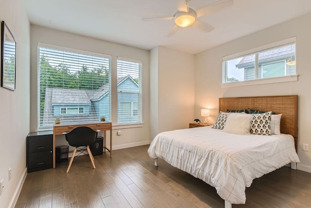 3001 Del Curto Rd Unit 11, Austin, TX 78704 - bedroom with multiple windows, baseboards, an office area, and wood finished floors
