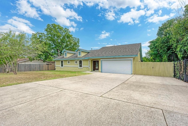 903 N Neans Dr, Austin, TX 78758 - view of front of house with driveway, an attached garage, roof with shingles, and stucco siding