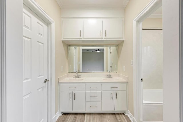 903 N Neans Dr, Austin, TX 78758 - full bathroom with double vanity, wood finished floors, ornamental molding, and a bath